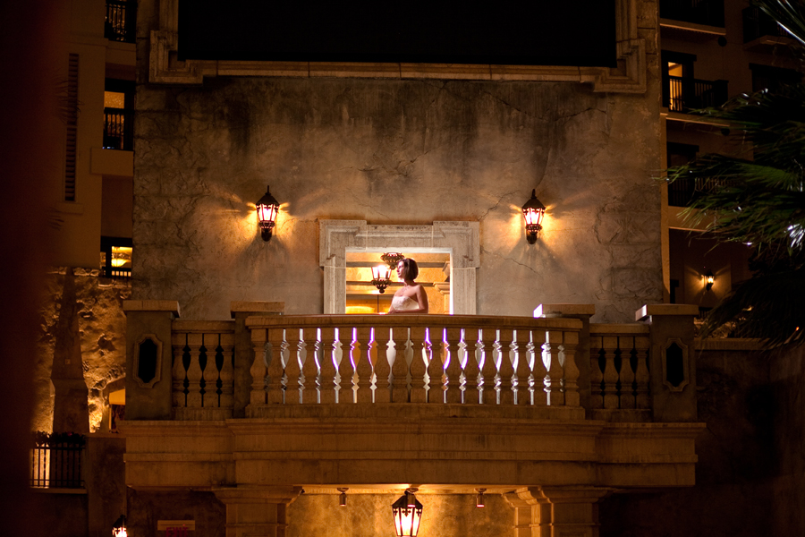 Bride on balcony of the gaylord texan for bridal portrait during wedding reception